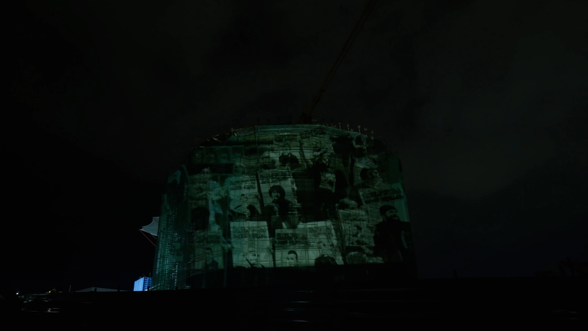 Protest expressed via projection mapping on a building safety netting